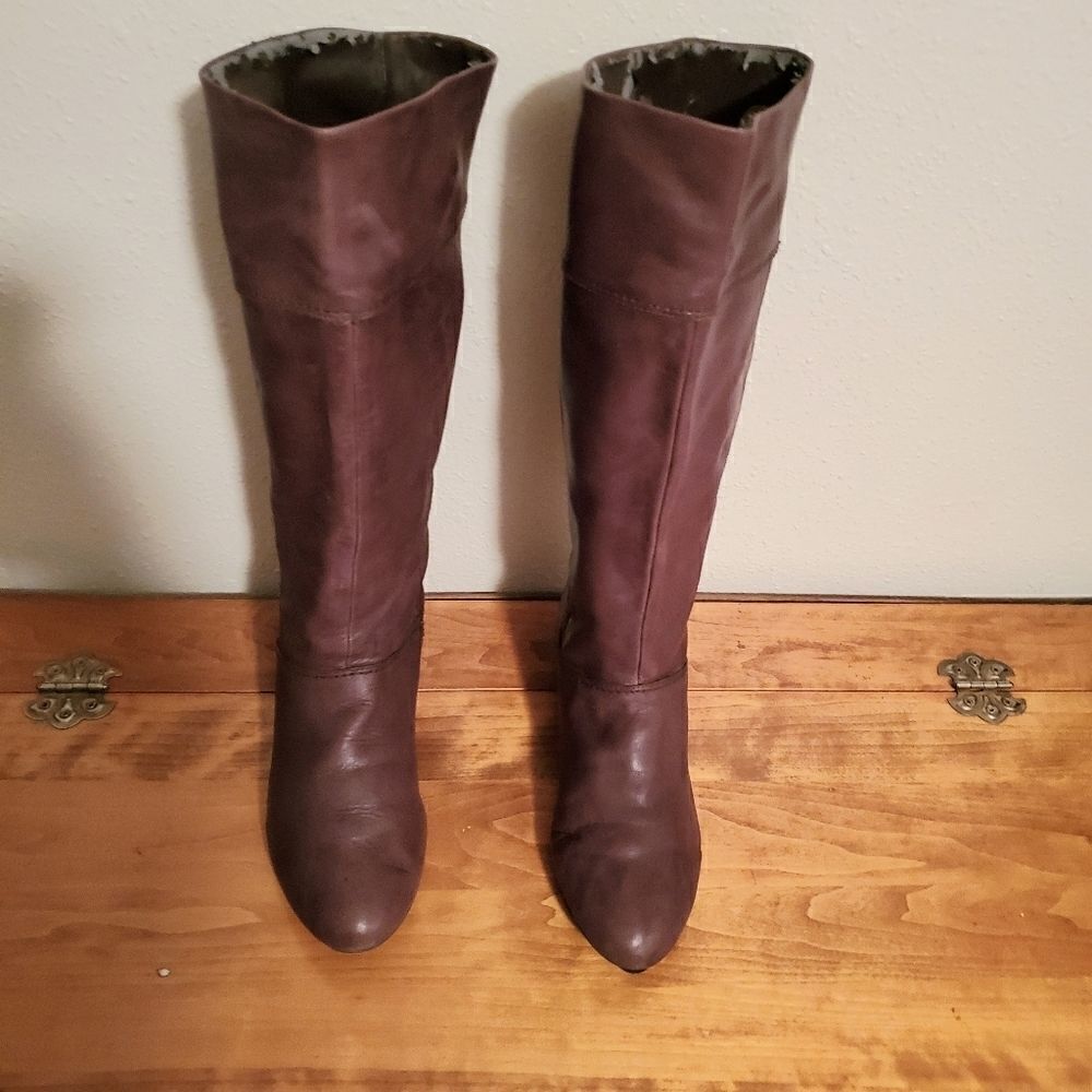 Knee high brown leather boots.